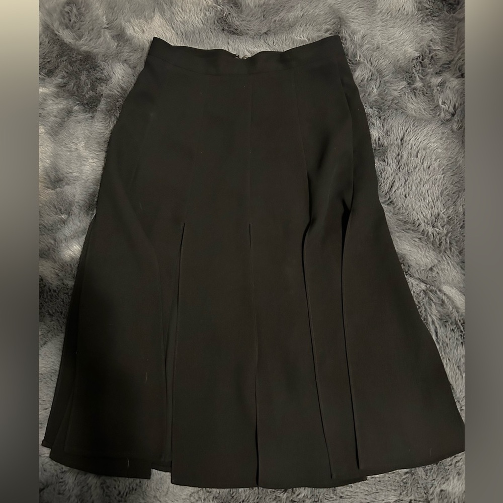 Black skirt by Ann Taylor in a size 0. Beautiful black-cut out slits skirt